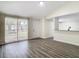 Bright living room with wood-look floors and view of kitchen at 10214 Turtle Hill Ct, Tampa, FL 33615