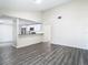 Open living area with grey wood-look floors and kitchen views at 10214 Turtle Hill Ct, Tampa, FL 33615