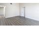 Simple living room with grey wood-like floor and white walls at 10214 Turtle Hill Ct, Tampa, FL 33615