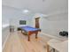 Game room with pool table, TV, and light hardwood floors at 1030 Bellasol Way # 402, Apollo Beach, FL 33572