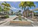 Resort-style pool area with a fountain and tiki bar at 1030 Bellasol Way # 402, Apollo Beach, FL 33572