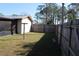 Fenced backyard with a grassy lawn and partial shade, perfect for relaxation and outdoor enjoyment at 10611 Fairfield Village Dr, Tampa, FL 33624