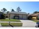 Charming single-story home featuring a well-manicured front yard and attached garage at 10611 Fairfield Village Dr, Tampa, FL 33624