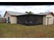 Rear view of house showing screened patio and yard at 10611 Fairfield Village Dr, Tampa, FL 33624