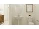 Convenient half bathroom with pedestal sink and toilet at 10859 Ibis Brook Ct, Land O Lakes, FL 34638