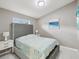 Grey bedroom with a tall headboard and beach themed bedding at 11123 Elmhurst Dr, Pinellas Park, FL 33782