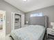 Bedroom with grey upholstered bed and white closet at 11123 Elmhurst Dr, Pinellas Park, FL 33782