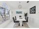 Bright dining room with white table, gray chairs, and large window at 11123 Elmhurst Dr, Pinellas Park, FL 33782