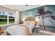 Charming bedroom with a tropical mural, bed and a guitar at 11285 Kingly Ln, Odessa, FL 33556