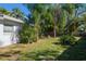 Large backyard with lush landscaping and mature trees at 11453 Imperial Grove E Dr, Largo, FL 33774