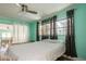 Bedroom with light-colored bedding and access to sunroom at 11453 Imperial Grove E Dr, Largo, FL 33774