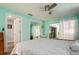 Bright bedroom with large windows, mirrored closet, and access to Florida room at 11453 Imperial Grove E Dr, Largo, FL 33774