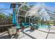 Relaxing pool area with patio furniture under a screened enclosure at 11453 Imperial Grove E Dr, Largo, FL 33774