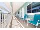 Inviting balcony with teal chairs and ocean views at 11730 Gulf Blvd # 49, St Petersburg, FL 33706