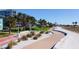 Beachfront walkway with palm trees, firepit, and shuffleboard at 11730 Gulf Blvd # 49, St Petersburg, FL 33706