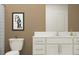 Modern bathroom with white vanity, beige walls, and a white toilet at 12215 Radiant Gem Trl, Parrish, FL 34219