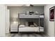 Bedroom with twin-over-full bunk bed, gray walls, and neutral decor at 12215 Radiant Gem Trl, Parrish, FL 34219