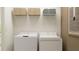 Bright laundry room with washer, dryer, and shelving at 12223 Radiant Gem Trl, Parrish, FL 34219