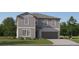 Two-story house with gray siding, a brown garage door, and landscaping at 12227 Radiant Gem Trl, Parrish, FL 34219