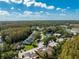 Aerial showing townhouses nestled in a wooded area near a lake at 12746 Wood Trail Blvd, Tampa, FL 33625