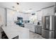 Modern white kitchen with stainless steel appliances and quartz countertops at 12746 Wood Trail Blvd, Tampa, FL 33625