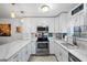 Modern white kitchen with quartz countertops and stainless steel appliances at 12746 Wood Trail Blvd, Tampa, FL 33625