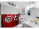 Laundry room with red washer and dryer set at 12746 Wood Trail Blvd, Tampa, FL 33625