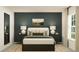 Bedroom with dark platform bed, neutral decor, and accent pillows at 12968 Shining Blue Nile Ln, Parrish, FL 34219