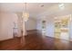 Open dining room with hardwood floors, chandelier, and kitchen views at 1454 Brigadier Dr, Spring Hill, FL 34608