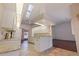 Bright kitchen with granite countertops, white cabinets, and skylights at 1454 Brigadier Dr, Spring Hill, FL 34608