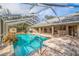 Large swimming pool with screened enclosure, and adjacent patio at 1454 Brigadier Dr, Spring Hill, FL 34608