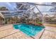 Stunning screened-in pool with spacious deck and backyard views at 1454 Brigadier Dr, Spring Hill, FL 34608