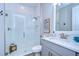 Clean bathroom with a walk-in shower and gray vanity at 14834 Paddock Pond Ave, Lithia, FL 33547