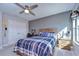 Charming bedroom with a rustic bed, desk, and large windows at 14834 Paddock Pond Ave, Lithia, FL 33547