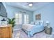 Cozy bedroom with light blue walls, comfortable bedding, and ceiling fan at 14834 Paddock Pond Ave, Lithia, FL 33547