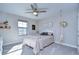 Bright bedroom with a queen-size bed and neutral decor at 14834 Paddock Pond Ave, Lithia, FL 33547