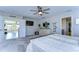 Main bedroom with carpet, dresser, and large TV at 14834 Paddock Pond Ave, Lithia, FL 33547