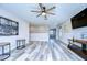 Spacious bonus room with hardwood floors, ceiling fan, and media area at 14834 Paddock Pond Ave, Lithia, FL 33547