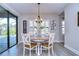 Bright dining area with farmhouse table and chairs, adjacent to kitchen at 14834 Paddock Pond Ave, Lithia, FL 33547