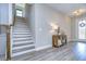 Bright entryway with staircase, console table, and natural light at 14834 Paddock Pond Ave, Lithia, FL 33547