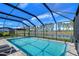 Sparkling screened pool with a view of the lake at 14834 Paddock Pond Ave, Lithia, FL 33547