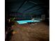 Night view of the pool area with lounge chairs at 14834 Paddock Pond Ave, Lithia, FL 33547