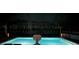 Luminous pool at night with surrounding lights at 14834 Paddock Pond Ave, Lithia, FL 33547