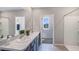 Modern bathroom with double vanity and walk-in shower at 1712 Tahitian Sunrise Dr, Plant City, FL 33565