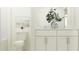 Bright bathroom with white cabinets, quartz countertop, and tiled shower at 17627 Happytrails St, Land O Lakes, FL 34638