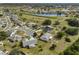 Aerial view of community, showing homes, landscaping, and a lake at 1807 Pineapple Palm Ct, Sun City Center, FL 33573