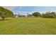 Large grassy backyard with mature trees at 1807 Pineapple Palm Ct, Sun City Center, FL 33573