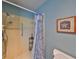 Simple bathroom featuring a shower, grab bar and updated tile at 1807 Pineapple Palm Ct, Sun City Center, FL 33573