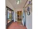 Enclosed front porch with tile flooring and access to interior at 1807 Pineapple Palm Ct, Sun City Center, FL 33573