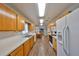 Modern kitchen with wood cabinets, tile flooring, and ample counter space at 1807 Pineapple Palm Ct, Sun City Center, FL 33573